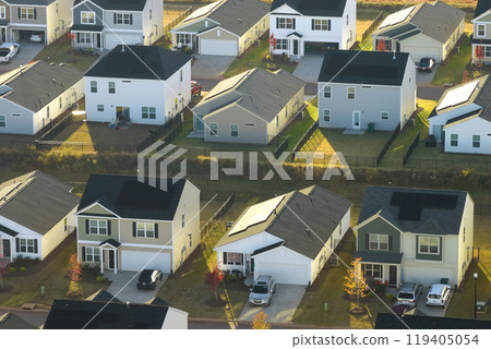Aerial view of tightly packed homes in South Carolina residential area. New family houses as example of real estate development in american suburbs Aerial view of tightly packed homes in South Carolina residential area. New family houses as example of real estate development in american suburbs 119405054