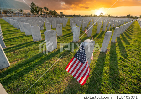 Army veteran cemetery with white headstones and USA flag. Tombs of retired military soldiers. Memorial Day concept Army veteran cemetery with white headstones and USA flag. Tombs of retired military soldiers. Memorial Day concept 119405071