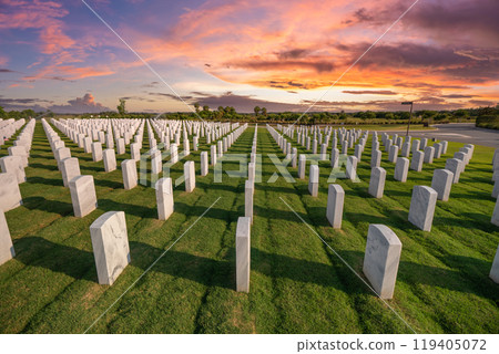Army veteran cemetery with white headstones. Tombs of retired military soldiers at sunset. Memorial Day concept Army veteran cemetery with white headstones. Tombs of retired military soldiers at sunset. Memorial Day concept 119405072