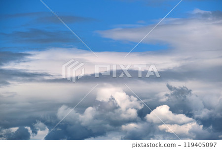 Bright landscape of white puffy cumulus clouds on blue clear sky. 119405097