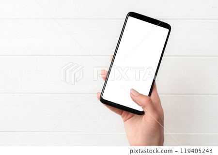 User holding smartphone with white screen User holding smartphone with white screen 119405243