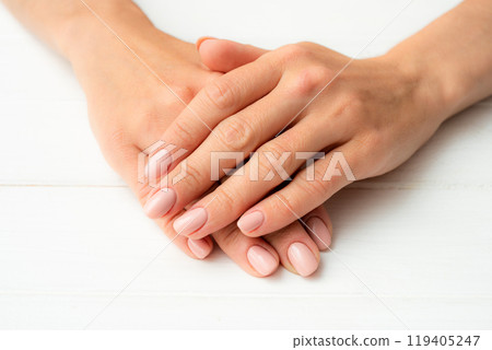 Woman's hands on a white table 119405247