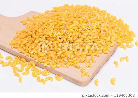 A Heap of Uncooked Chifferi Rigati Pasta on Wooden Kitchen Board 119405308