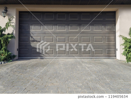 Modern garage door with paved driveway 119405634