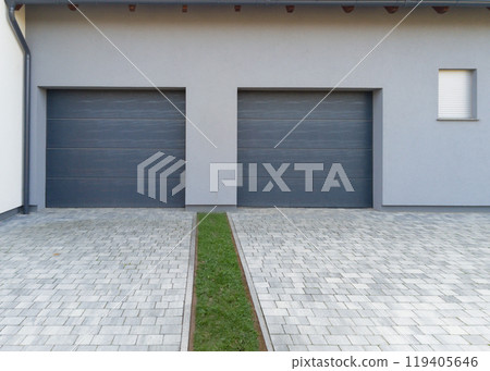 Modern double garage with paved driveway Modern double garage with paved driveway 119405646