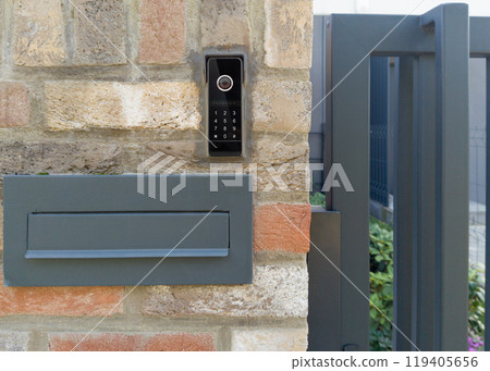 Modern mailbox and video intercom on brick wall Modern mailbox and video intercom on brick wall 119405656