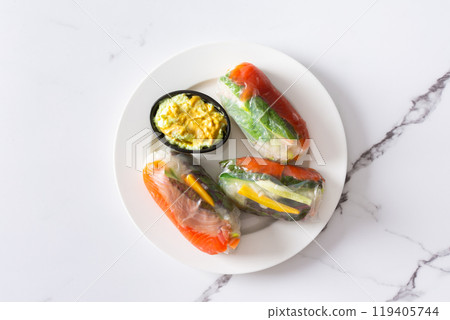 Enjoy Vietnamese spring rolls with rice paper, fresh lettuce, salmon, carrots, cucumber, and fish sauce, blending Asian and Thai cuisine for a delicious Enjoy Vietnamese spring rolls with rice paper, fresh lettuce, salmon, carrots, cucumber, and fish sauce, blending Asian and Thai cuisine for a delicious 119405744