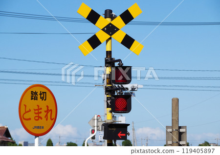A railroad crossing alarm with a left-pointing arrow on it A railroad crossing alarm with a left-pointing arrow on it 119405897
