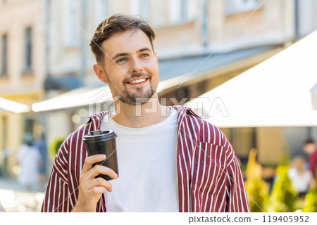 Handsome adult man enjoying drinking morning coffee hot drink relaxing taking a break on city street 119405952