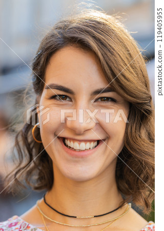 Happy young woman smiling looking away dreaming, resting, good news, feel satisfied in city street 119405955