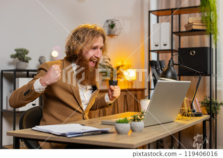 Business man working on laptop shocked by sudden victory, game winning lottery good career news mail Business man working on laptop shocked by sudden victory, game winning lottery good career news mail 119406016