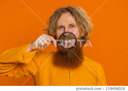 Happy smiling Caucasian man holding magnifier glass on teeth health care hygiene stomatology concept Happy smiling Caucasian man holding magnifier glass on teeth health care hygiene stomatology concept 119406020