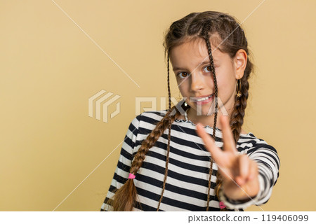 Happy smiling child girl kid showing victory sign, hoping for success and win, doing peace gesture Happy smiling child girl kid showing victory sign, hoping for success and win, doing peace gesture 119406099