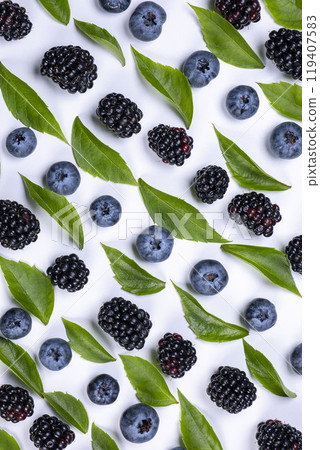 blackberries and blueberries on a white background, close-up, top view. blackberries and blueberries on a white background, close-up, top view. 119407583