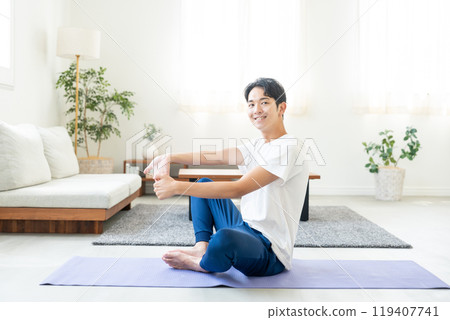 Young man doing yoga at home 119407741