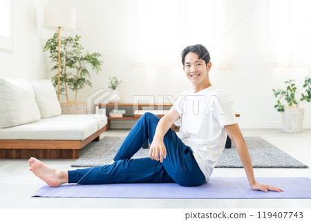 Young man doing yoga at home 119407743