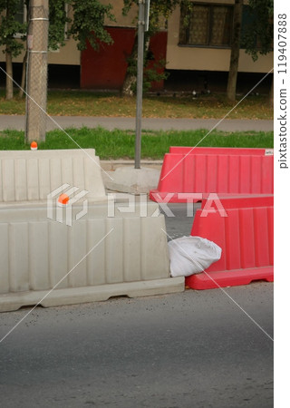 Red, white plastic safety barriers along roads. Ensuring road safety with visible barriers Red, white plastic safety barriers along roads. Ensuring road safety with visible barriers 119407888