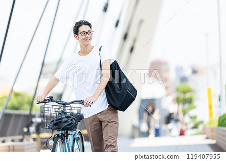 Young man pushing a bicycle Young man pushing a bicycle 119407955