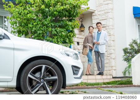 Middle-aged couple, house, car Middle-aged couple, house, car 119408060