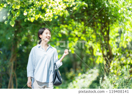 A woman walking in the fresh green A woman walking in the fresh green 119408141