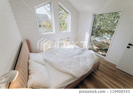 Minimalist cozy bedroom with natural light, modern interior design, and large windows  119408543