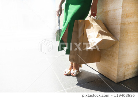 Front view close up legs of a beauty woman walking holding shopping bags 119408656