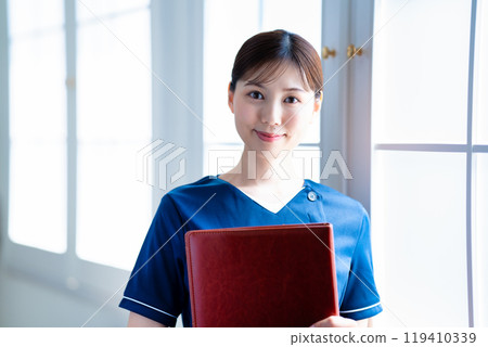 Female staff holding a binder Female staff holding a binder 119410339