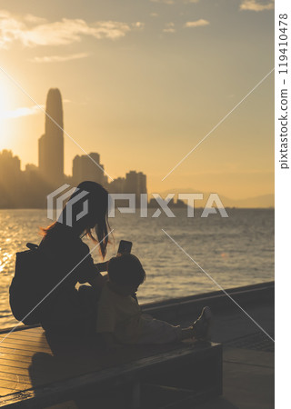 Oct 13 2024 Sunset behind Hong Kong Skyline and Skyscrapers 119410478