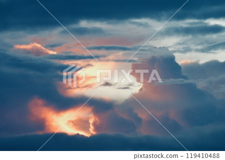 Sunrise clouds visible through a gap in the clouds 119410488