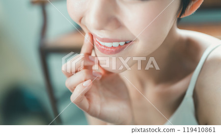 Young woman practicing smiling Young woman practicing smiling 119410861