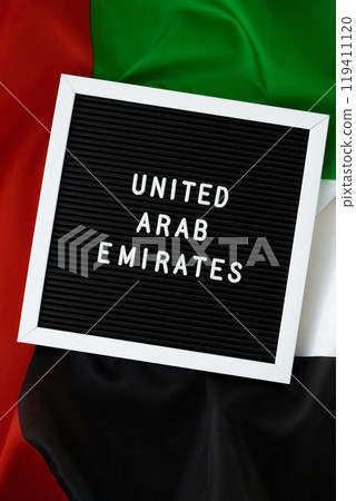 Message UNITED ARAB EMIRATES on background waving flag of UAE. National holiday, Independence Commemoration Day Muslim, congratulations. Arabian holidays. Advertisement 119411120