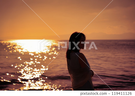 The sunset sea and women 119411126