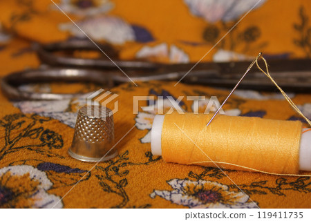 Golden Yellow Thread on Vintage Fabric Close-up Golden Yellow Thread on Vintage Fabric Close-up 119411735