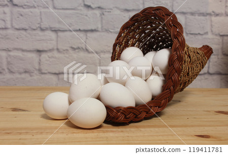 Basket of Farm Fresh Chicken Eggs on kitchen Table Basket of Farm Fresh Chicken Eggs on kitchen Table 119411781