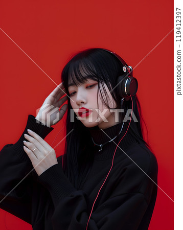 Fashion photo of an Asian woman listening to music through headphones 119412397
