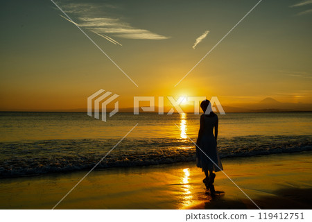The sunset sea and women 119412751
