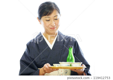 A middle-aged woman in a kimono carrying a meal 119412753