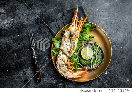 Grilled Spiny lobster with salad on a plate. Black background. Top view Grilled Spiny lobster with salad on a plate. Black background. Top view 119413109