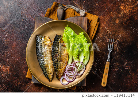 Grilled mackerel scomber fish fillets with garnish in a plate. Dark background. Top view Grilled mackerel scomber fish fillets with garnish in a plate. Dark background. Top view 119413114