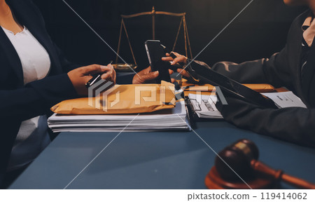 Judge gavel with Justice lawyers having team meeting at law firm background. Concepts of Law and Legal services. 119414062