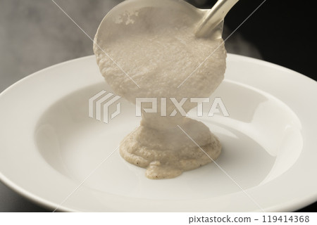 Mushroom potage: Ladle the potage onto a plate 119414368