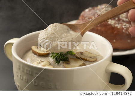 Mushroom potage - Pick up the mushroom potage soup with a spoon 119414572