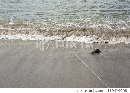 A shoe washed up on the shore A shoe washed up on the shore 119414608
