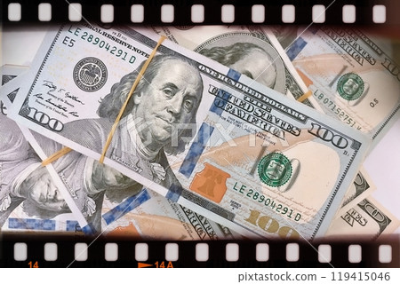 A Fan of $100 Bills.A close-up photo of a fan of $100 US dollar bills. The bills are arranged neatly, with the portrait of Benjamin Franklin visible on each bill.  119415046