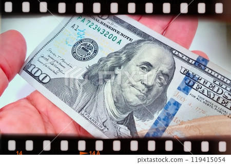 A Fan of $100 Bills.A close-up photo of a fan of $100 US dollar bills. The bills are arranged neatly, with the portrait of Benjamin Franklin visible on each bill.  119415054