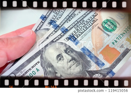A Fan of $100 Bills.A close-up photo of a fan of $100 US dollar bills. The bills are arranged neatly, with the portrait of Benjamin Franklin visible on each bill.  119415056