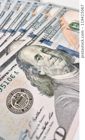 A Fan of $100 Bills.A close-up photo of a fan of $100 US dollar bills. The bills are arranged neatly, with the portrait of Benjamin Franklin visible on each bill.  119415067