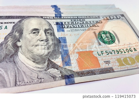 A Fan of $100 Bills.A close-up photo of a fan of $100 US dollar bills. The bills are arranged neatly, with the portrait of Benjamin Franklin visible on each bill.  119415073