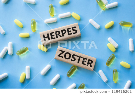 Herpes Zoster symbol. Concept word Herpes Zoster on wooden blocks. Beautiful blue background with pills. Medicine and Herpes Zoster concept. Copy space Herpes Zoster symbol. Concept word Herpes Zoster on wooden blocks. Beautiful blue background with pills. Medicine and Herpes Zoster concept. Copy space 119416261