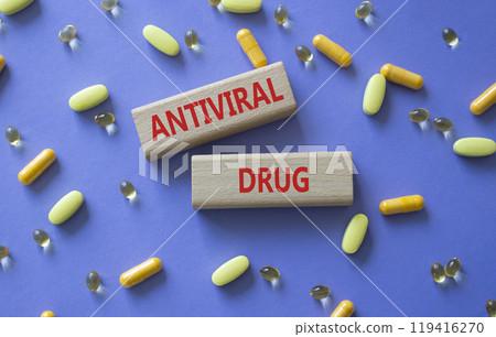 Antiviral Drug symbol. Concept words Antiviral Drug on wooden blocks. Beautiful purple background with pills. Medicine and Antiviral Drug concept. Copy space. Antiviral Drug symbol. Concept words Antiviral Drug on wooden blocks. Beautiful purple background with pills. Medicine and Antiviral Drug concept. Copy space. 119416270